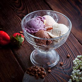 From above scoops of ice cream with chocolate drops and strawber